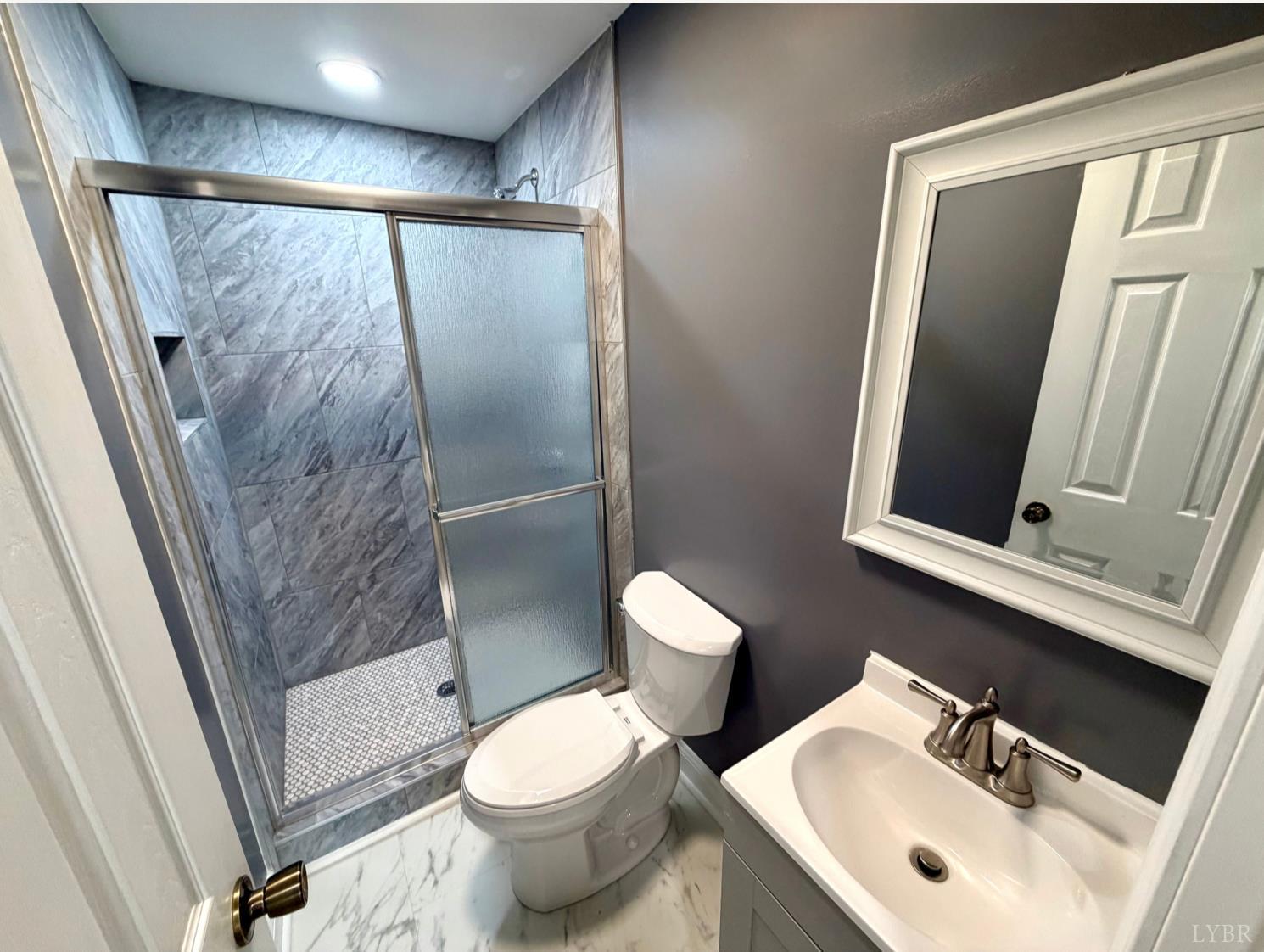 117 Monroe Street Monroe, VA 24574 - Photo 15 of 37 a bathroom with a sink and mirror with toilet