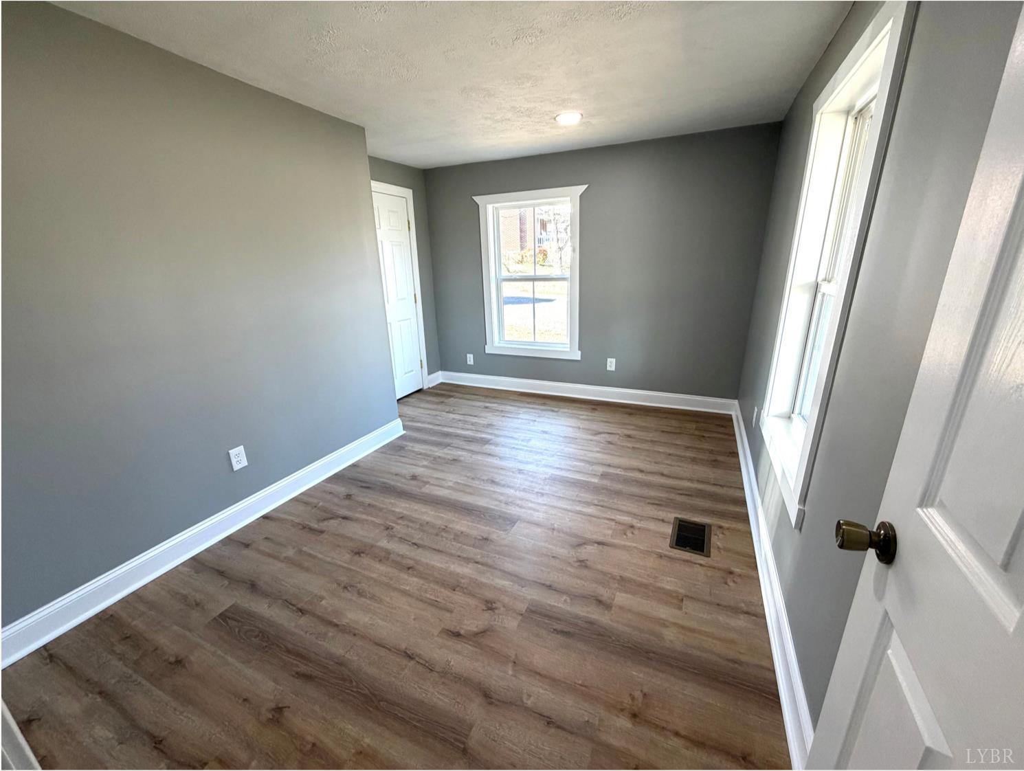 117 Monroe Street Monroe, VA 24574 - Photo 17 of 37 an empty room with wooden floor and window