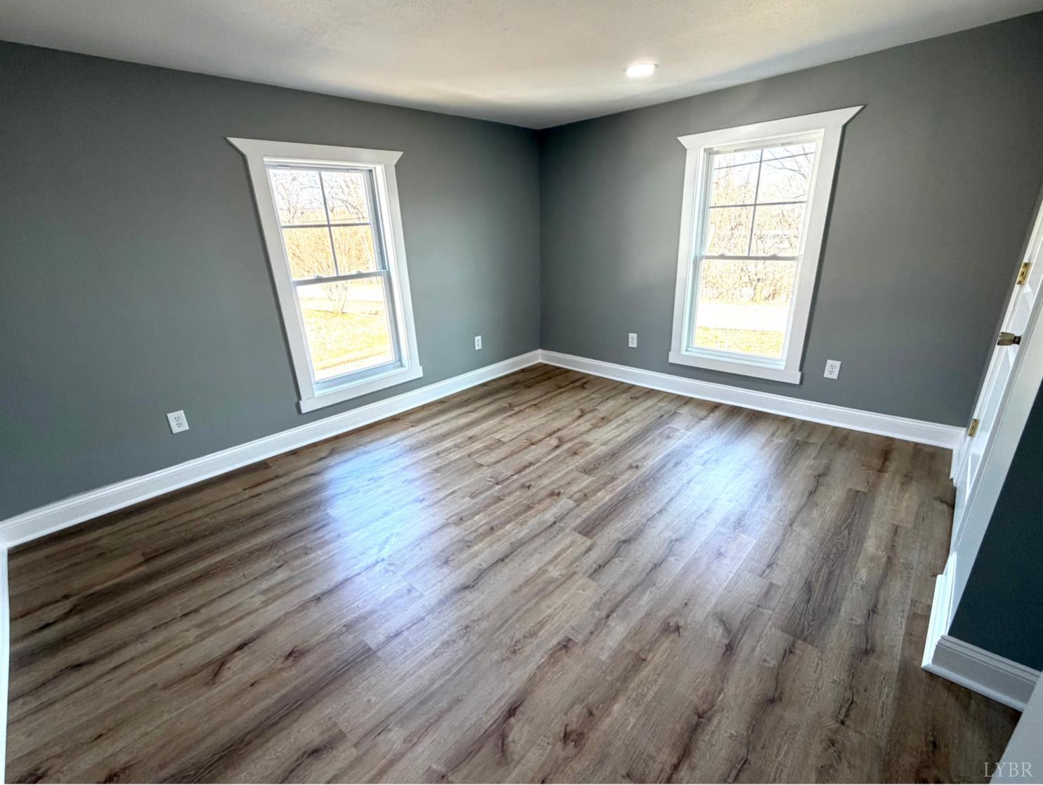 117 Monroe Street Monroe, VA 24574 - Photo 19 of 37 an empty room with wooden floor and windows