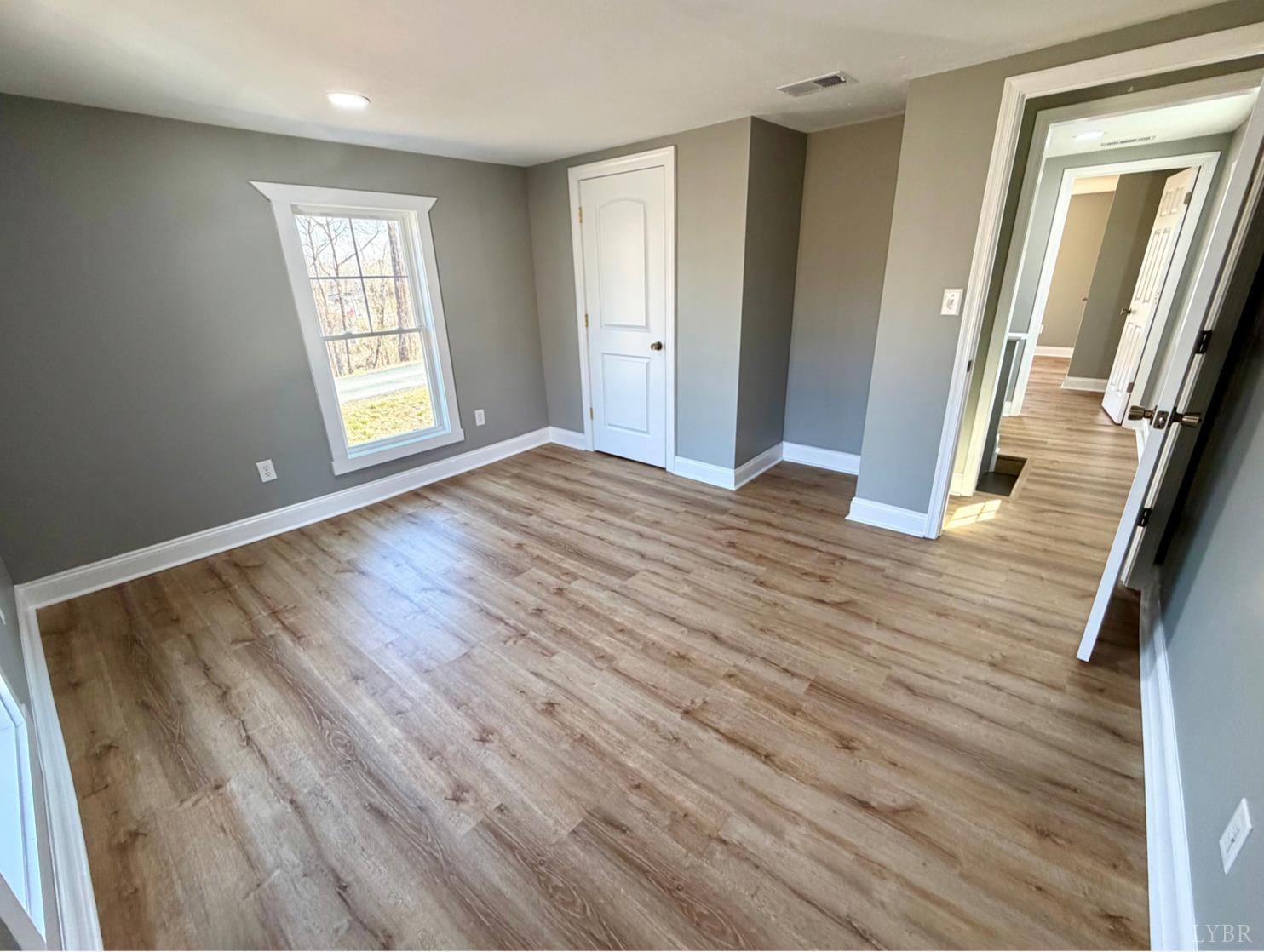 117 Monroe Street Monroe, VA 24574 - Photo 20 of 37 an empty room with wooden floor and windows