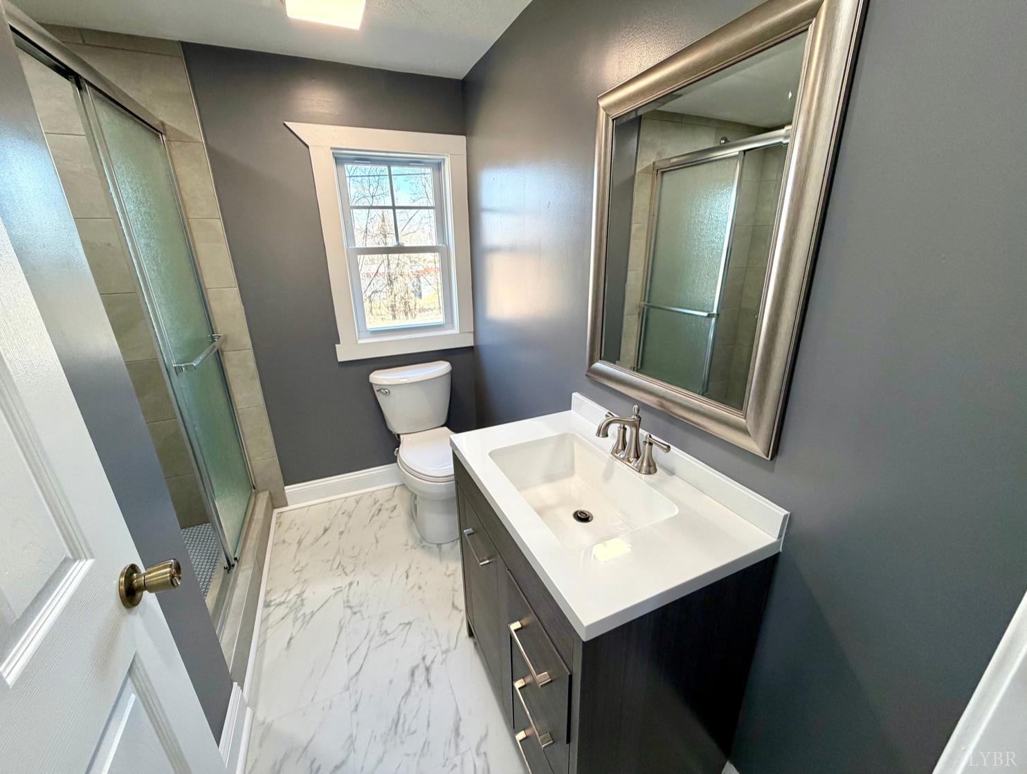 117 Monroe Street Monroe, VA 24574 - Photo 21 of 37 a bathroom with a sink a mirror and a toilet