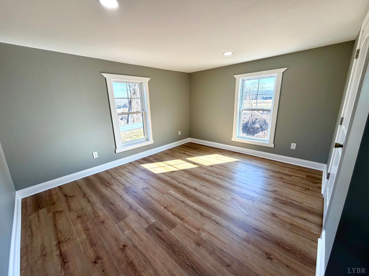117 Monroe Street Monroe, VA 24574 - Photo 23 of 37 a view of an empty room with wooden floor and a window