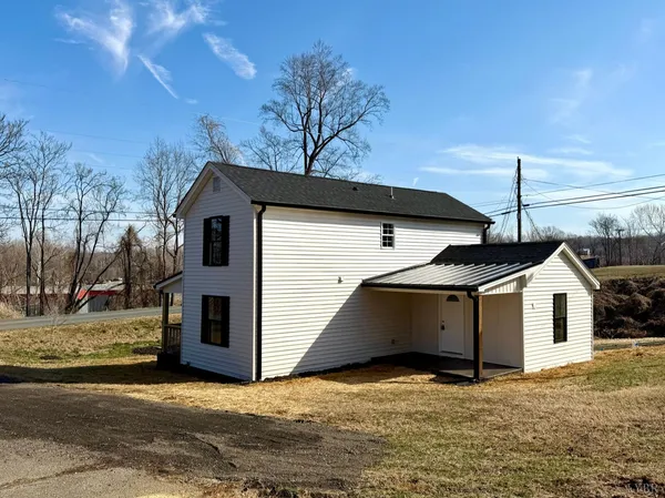 a view of a house with a snow in the yard