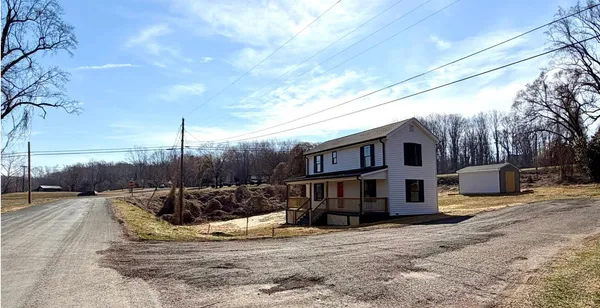 a view of a house with a yard covered in snow