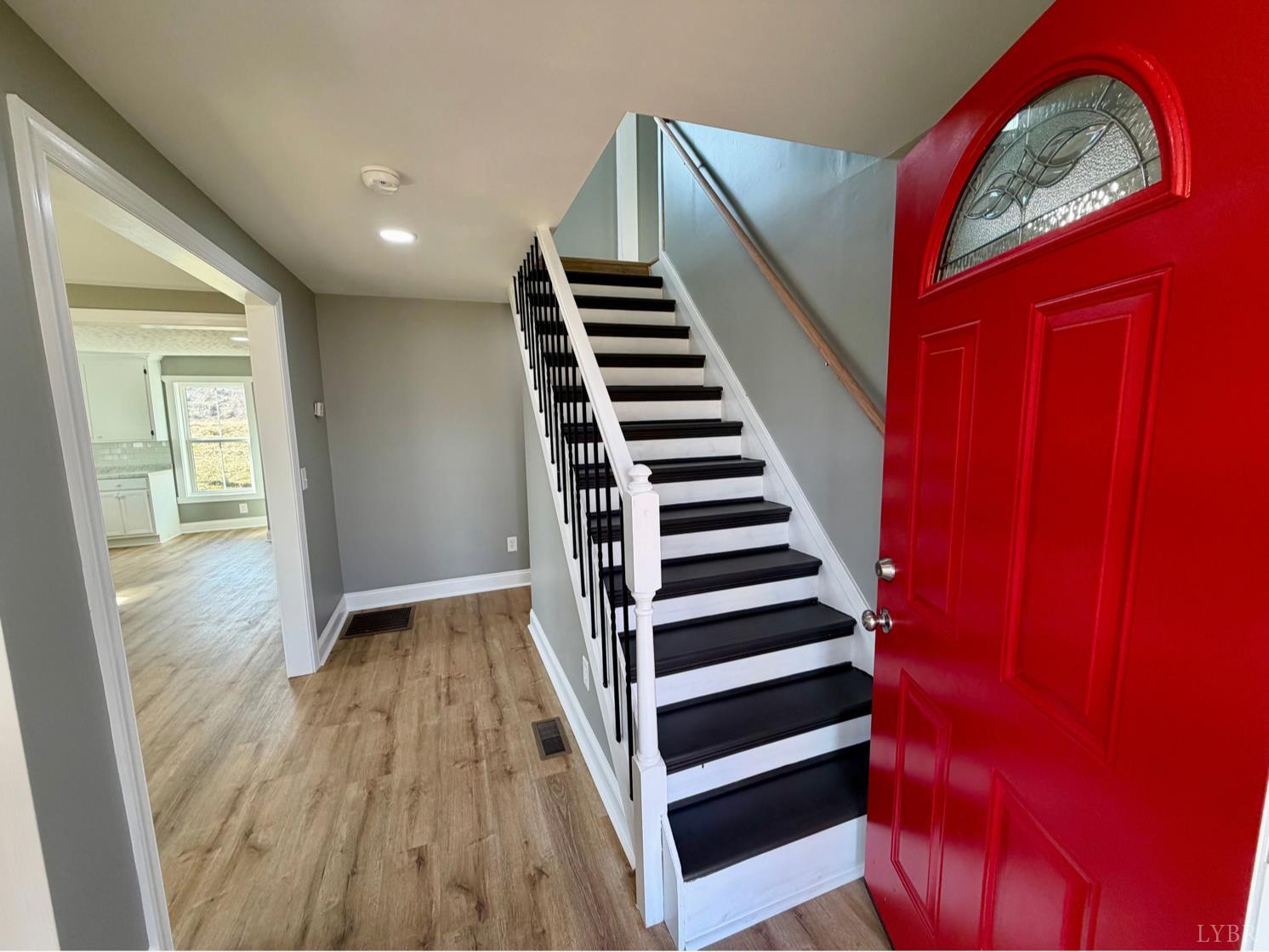 117 Monroe Street Monroe, VA 24574 - Photo 6 of 37 a view of a hallway with wooden floor and windows