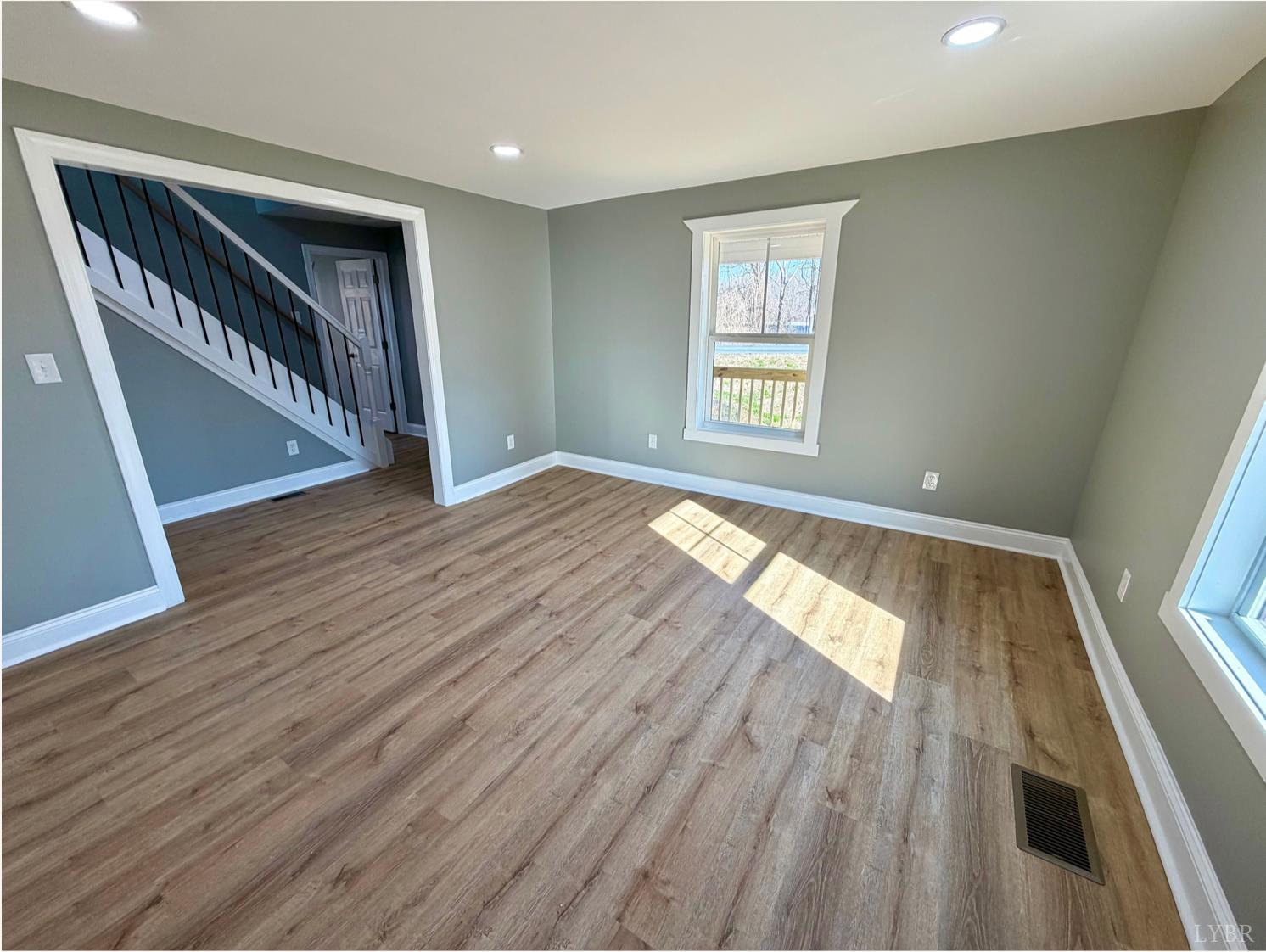 117 Monroe Street Monroe, VA 24574 - Photo 8 of 37 wooden floor in an empty room with a window