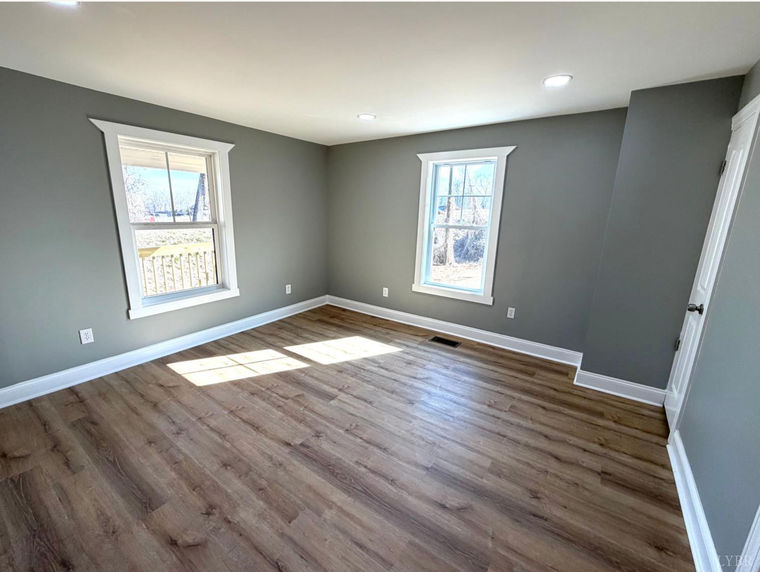 117 Monroe Street Monroe, VA 24574 - Photo 9 of 37 an empty room with wooden floor and windows