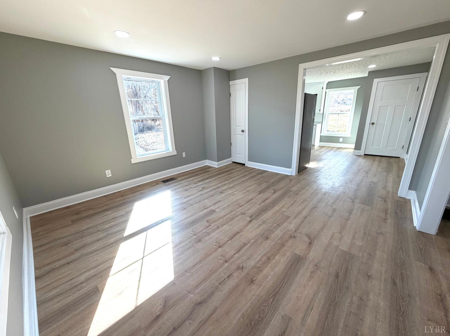 117 Monroe Street Monroe, VA 24574 - Photo 10 of 37 a view of an empty room with wooden floor and a window