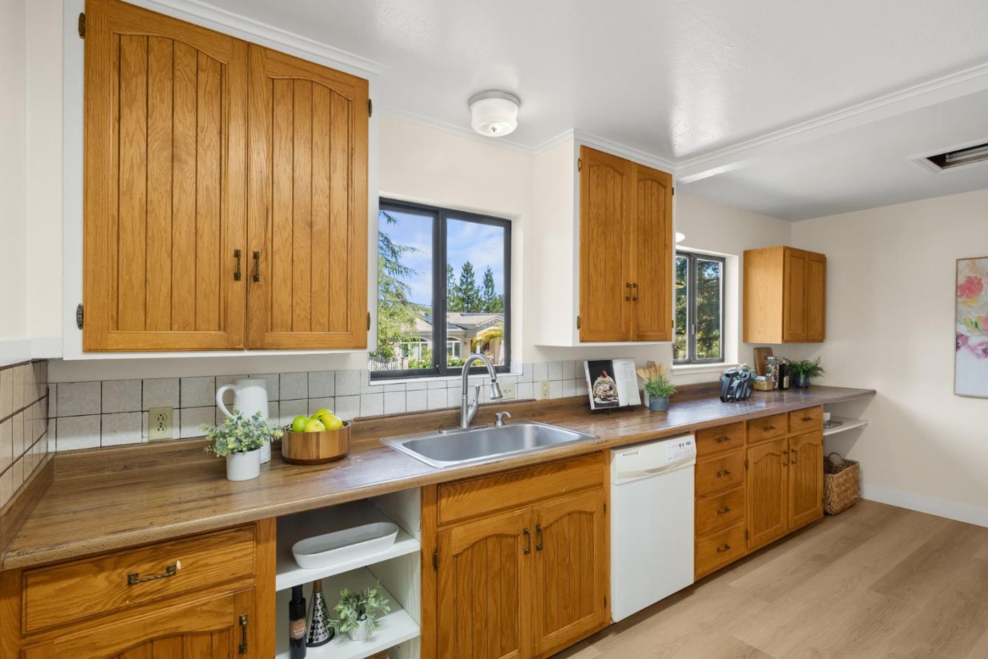 20540 Leonard Road Saratoga, CA 95070 - Photo 17 of 49 a kitchen with stainless steel appliances a sink a stove and cabinets