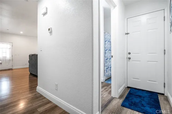 a view of hallway with wooden floor
