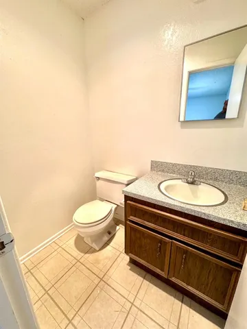 a bathroom with a toilet a sink and mirror