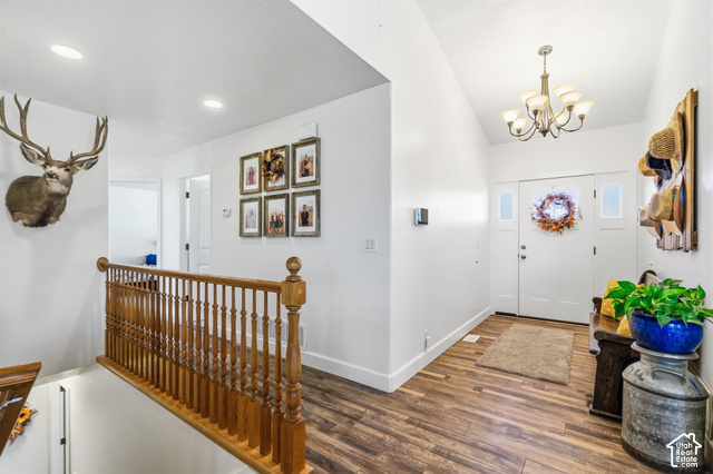 9044 North Cedar Pass Road Eagle Mountain, UT 84005 - Photo 18 of 63 Wood-finish flooring, white walls, and a wood banister