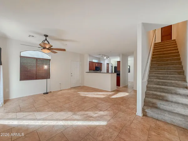 a view of a livingroom with wooden floor and stairs