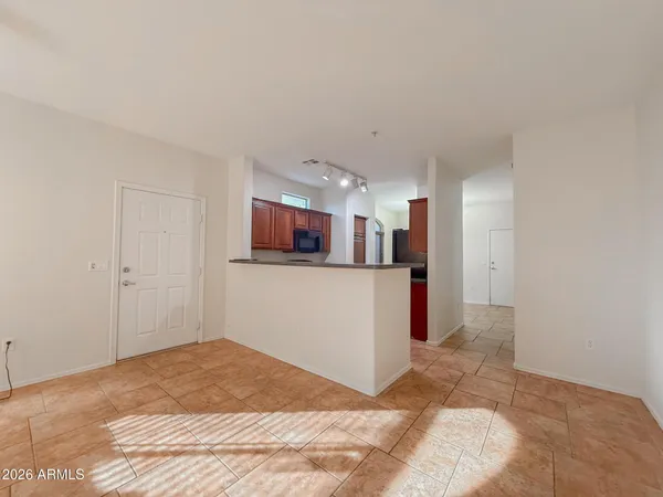 a bedroom with a bed and the view of kitchen