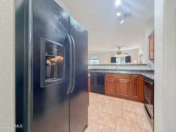 a bathroom with a granite countertop sink and mirror