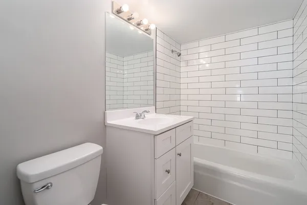 a bathroom with a sink a toilet and bathtub