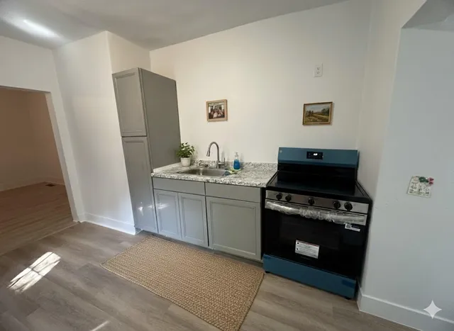 a kitchen with a stove and a refrigerator