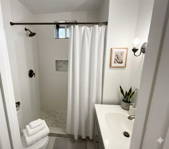 a bathroom with a sink a toilet and shower