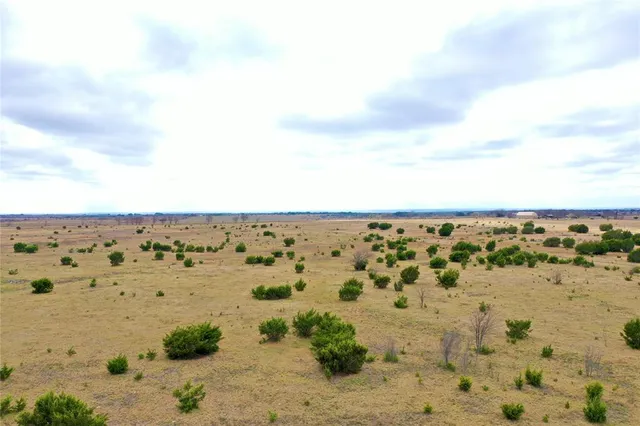 an aerial view of beach and building