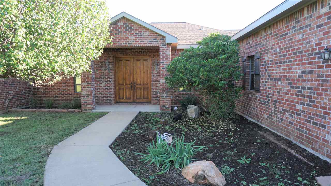 421 The Hills Road Horseshoe Bay, TX 78657 - Photo 1 of 1 a front view of a house with garden