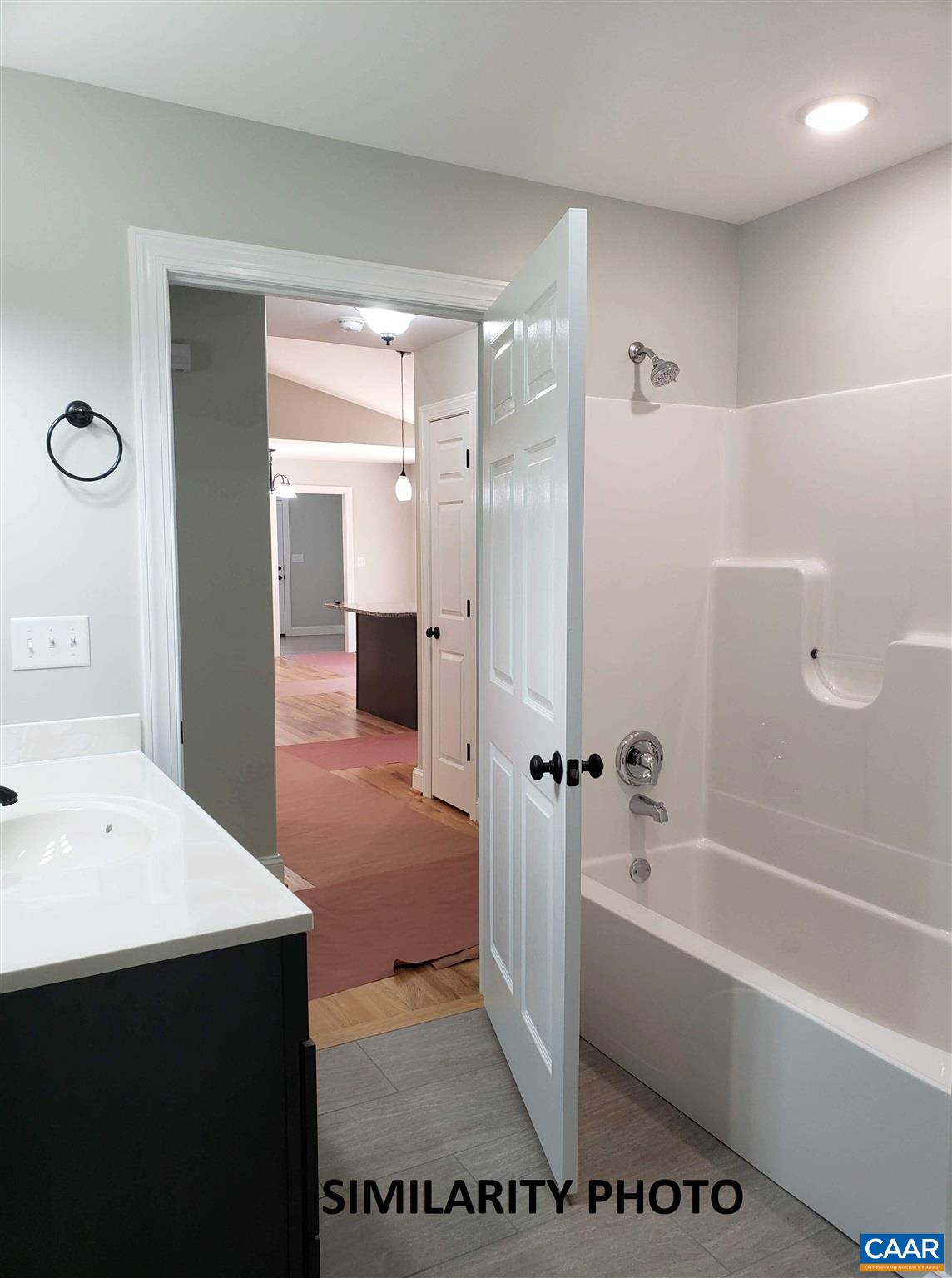 379 Carpenters Mill Road Pratts, VA 22731 - Photo 17 of 20 a bathroom with a bathtub a sink and a mirror