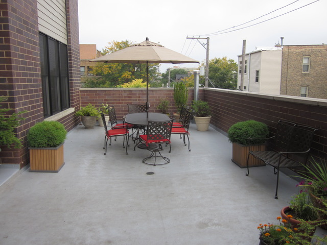 1842 West Irving Park Road, Unit 201 Chicago, IL 60613 - Photo 11 of 13 a view of backyard with outdoor seating and plants