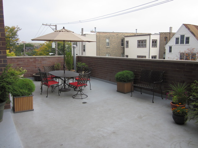 1842 West Irving Park Road, Unit 201 Chicago, IL 60613 - Photo 12 of 13 a view of a patio with a table and a chairs