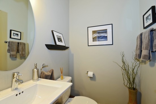 1842 West Irving Park Road, Unit 201 Chicago, IL 60613 - Photo 9 of 13 a bathroom with a sink mirror and toilet