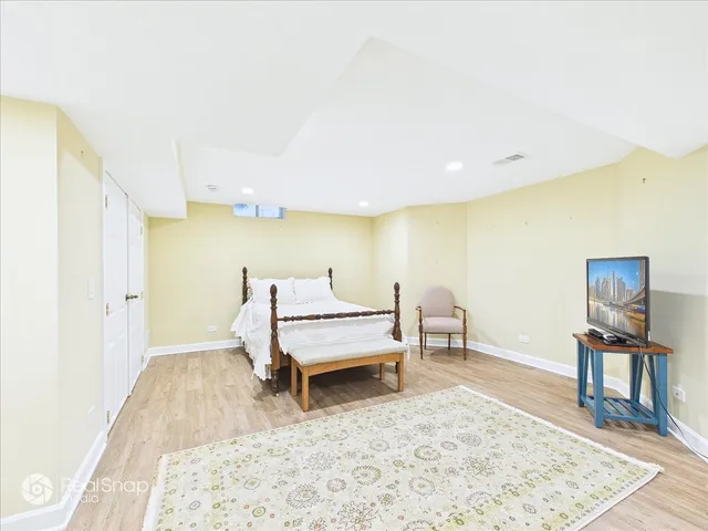 a bedroom with a bed and a dresser in it