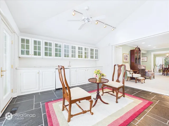 a living room with furniture a rug and a table