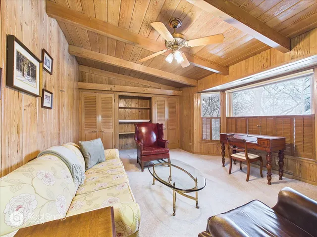 a living room with furniture a ceiling fan and a window