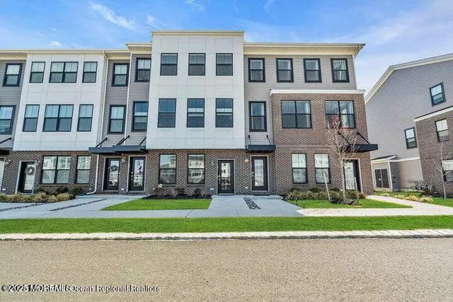 a front view of building with yard and green space