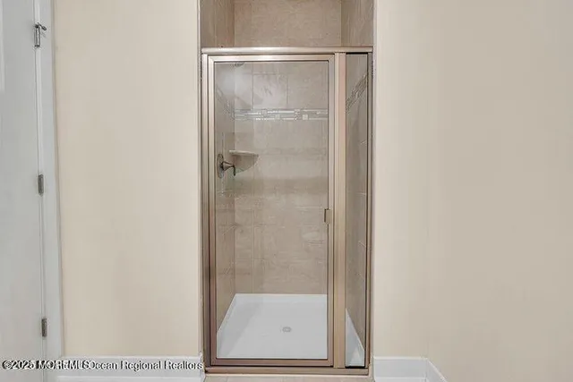 a bathroom with a glass shower door