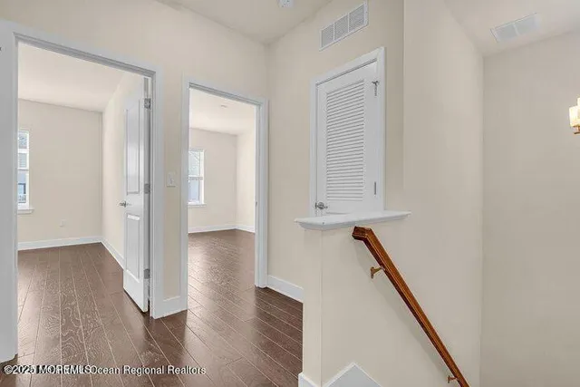 a view of hallway with wooden floor
