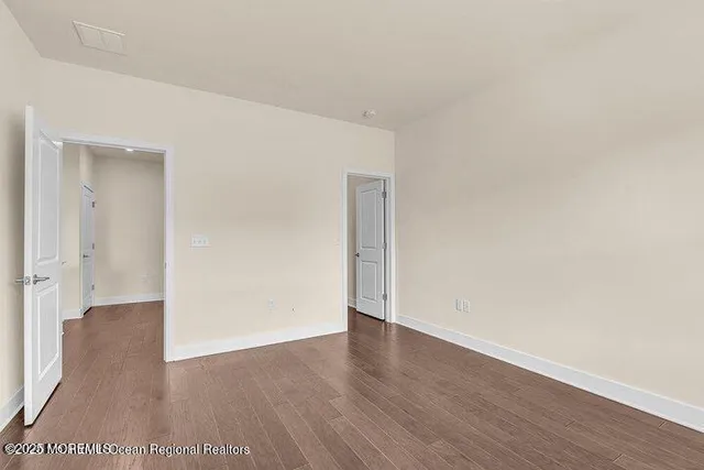 an empty room with wooden floor