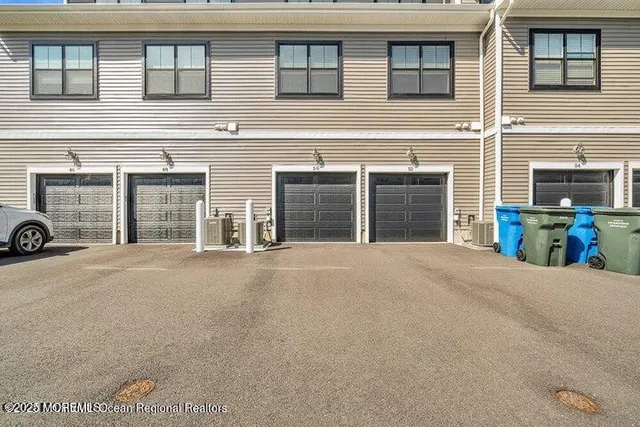 a front view of a house with a yard and a garage