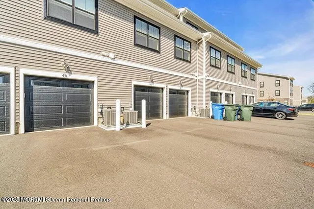 a car parked in front of a white building