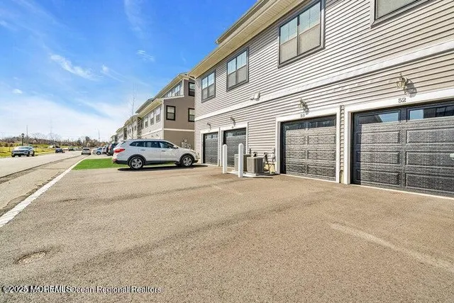 a car parked in front of a white building
