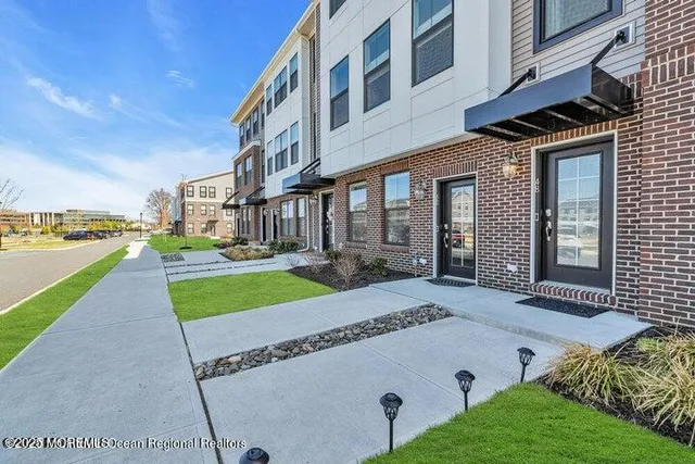 a view of a house with a yard and table and chairs