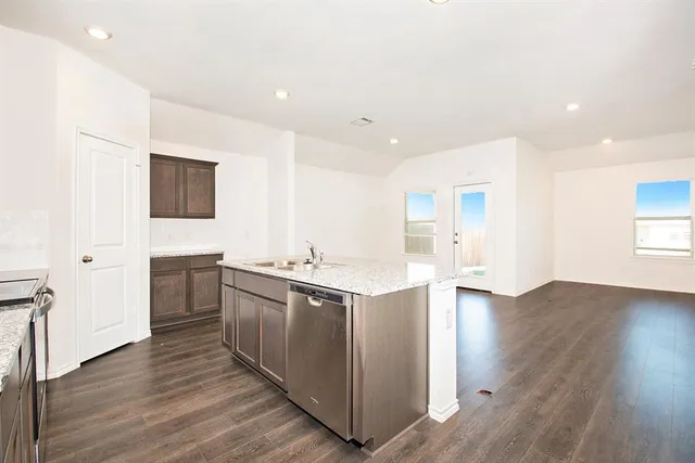 a kitchen with stainless steel appliances granite countertop a stove and a sink