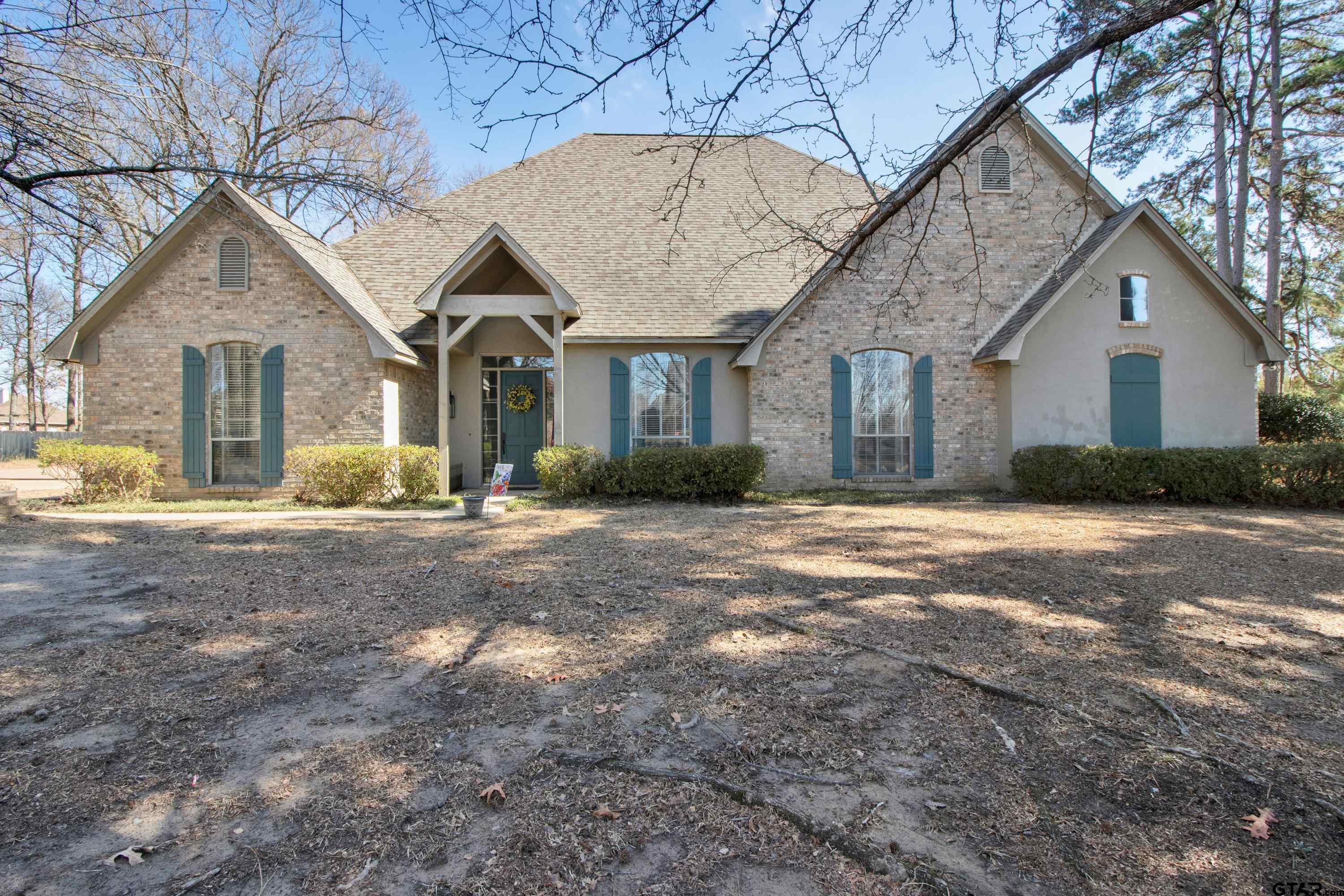 3800 Holly Ridge Drive Longview, TX 75605 - Photo 1 of 38 a front view of a house with a yard