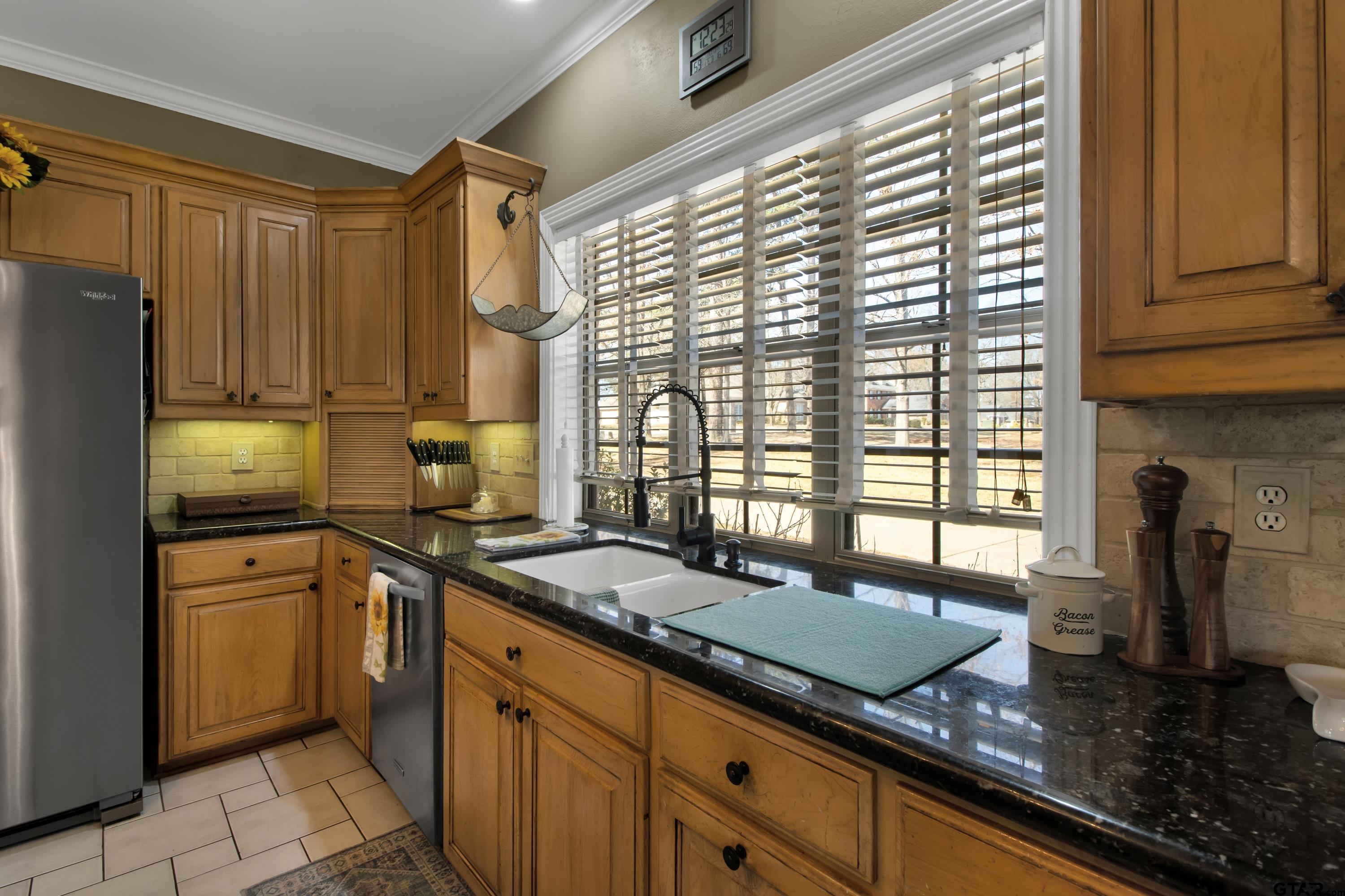 3800 Holly Ridge Drive Longview, TX 75605 - Photo 12 of 38 a kitchen with granite countertop a sink a counter top space and stainless steel appliances