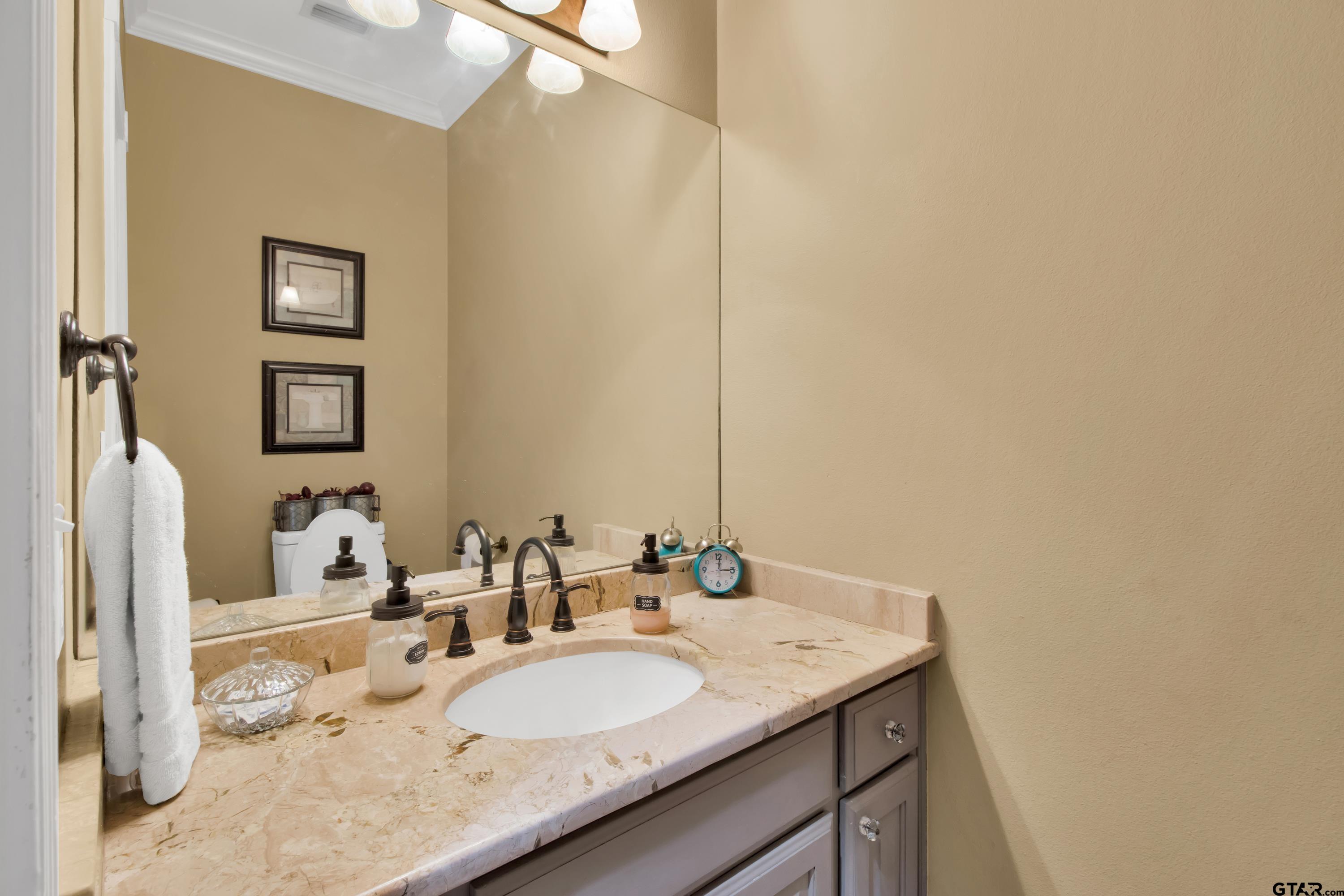 3800 Holly Ridge Drive Longview, TX 75605 - Photo 14 of 38 a bathroom with a granite countertop sink and a mirror