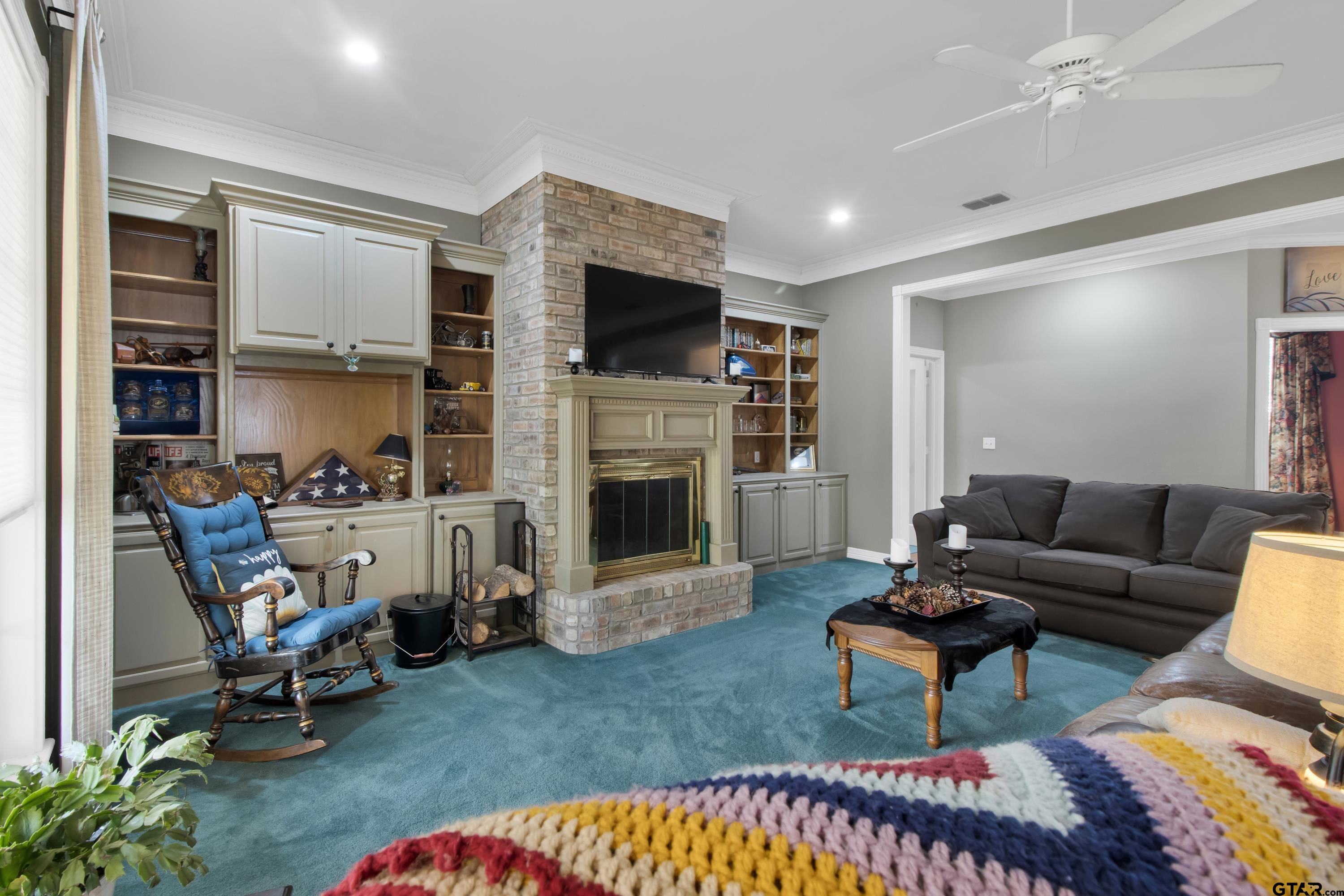 3800 Holly Ridge Drive Longview, TX 75605 - Photo 15 of 38 a living room with furniture a flat screen tv and a fireplace