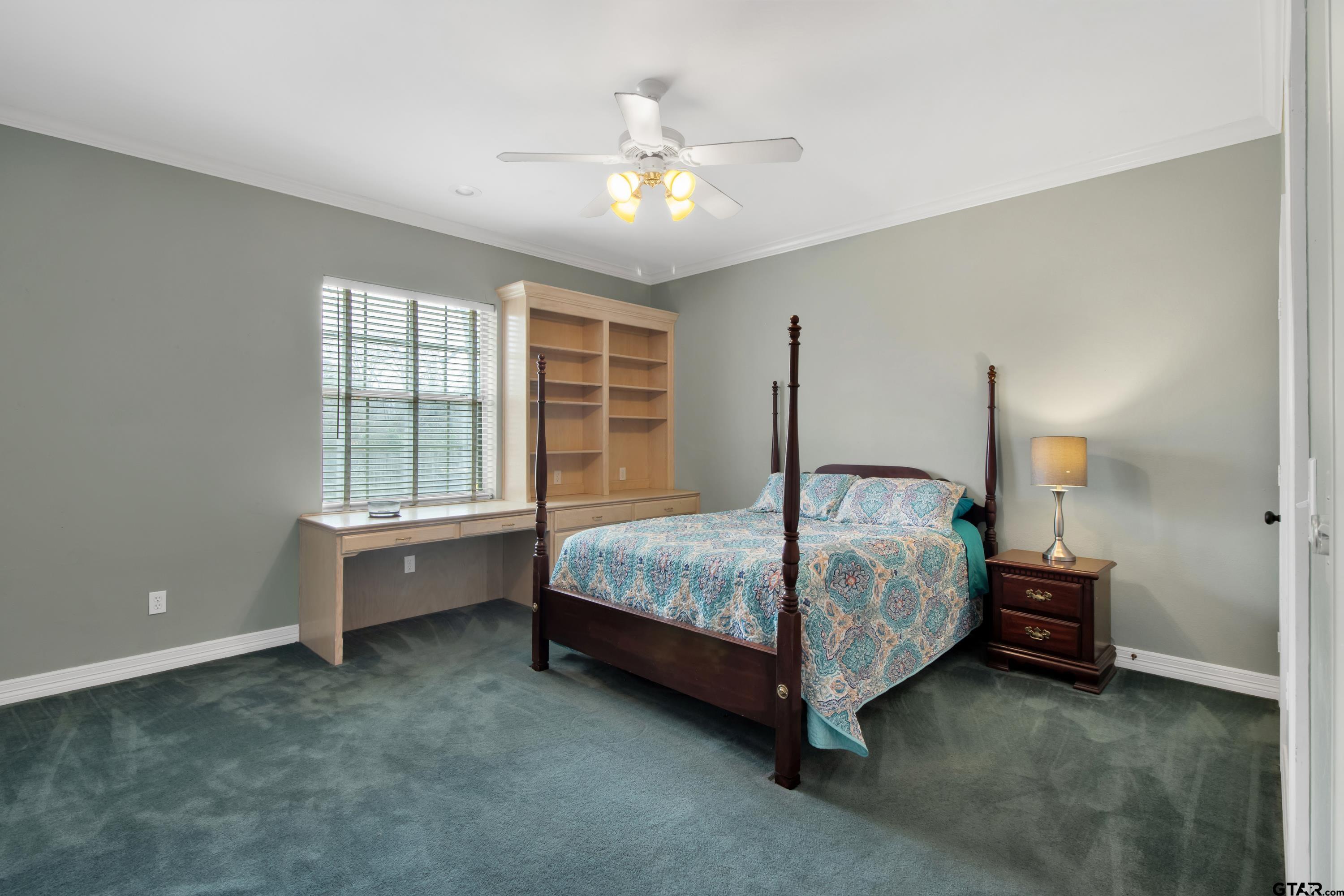 3800 Holly Ridge Drive Longview, TX 75605 - Photo 18 of 38 a bedroom with a bed and a chandelier