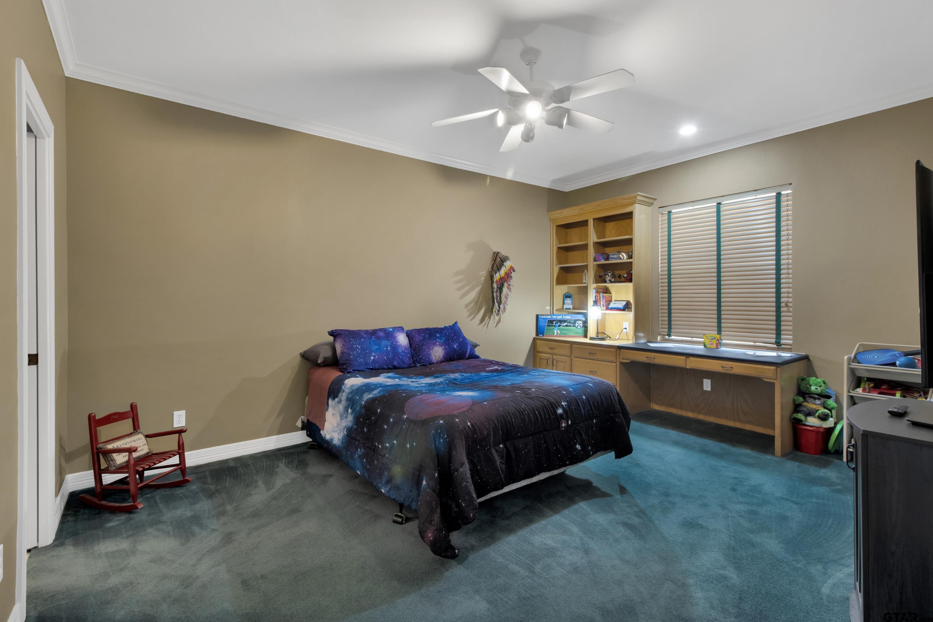 3800 Holly Ridge Drive Longview, TX 75605 - Photo 27 of 38 a bedroom with a bed and a chandelier