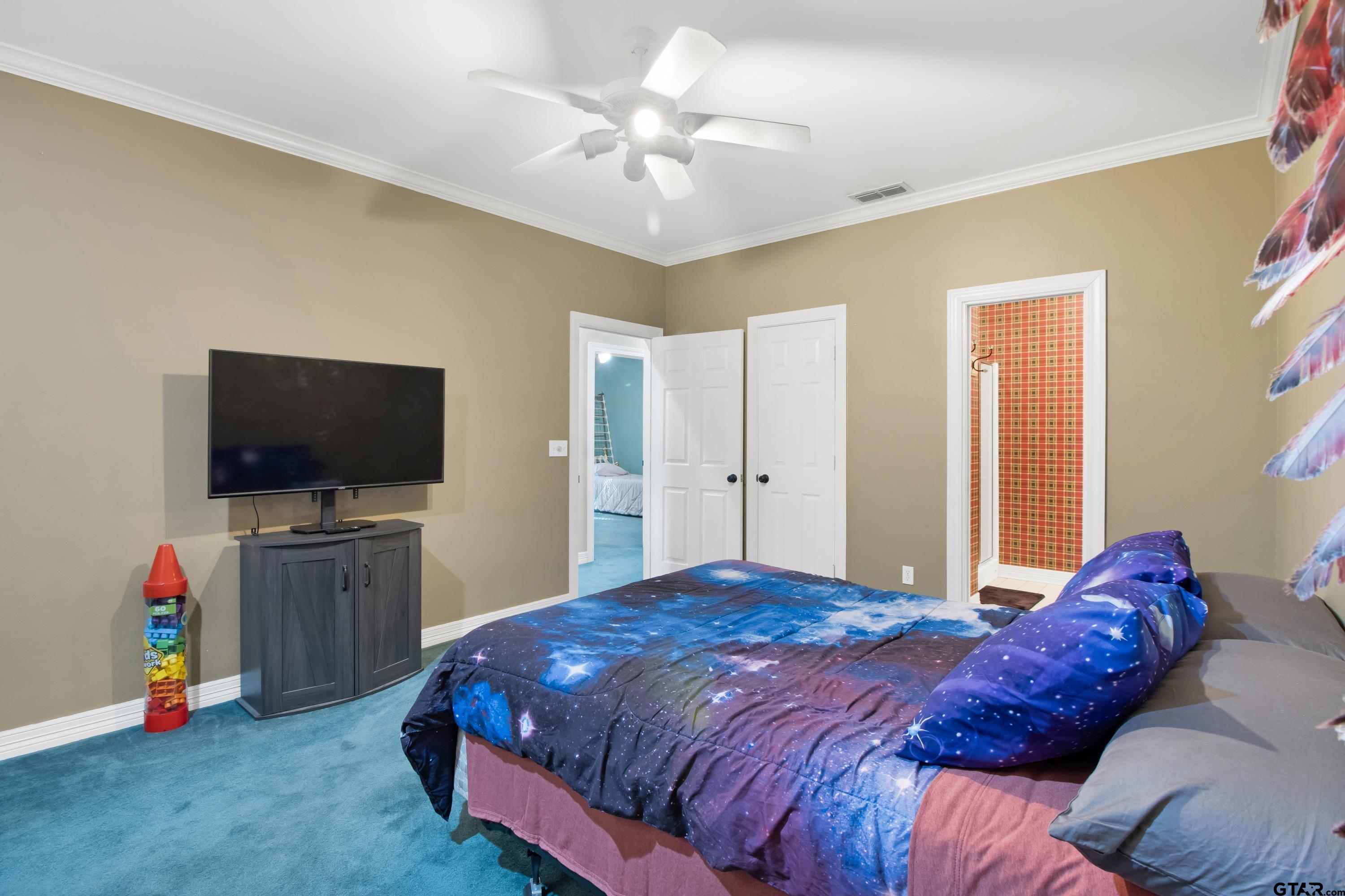 3800 Holly Ridge Drive Longview, TX 75605 - Photo 28 of 38 a bedroom with a bed and a flat screen tv