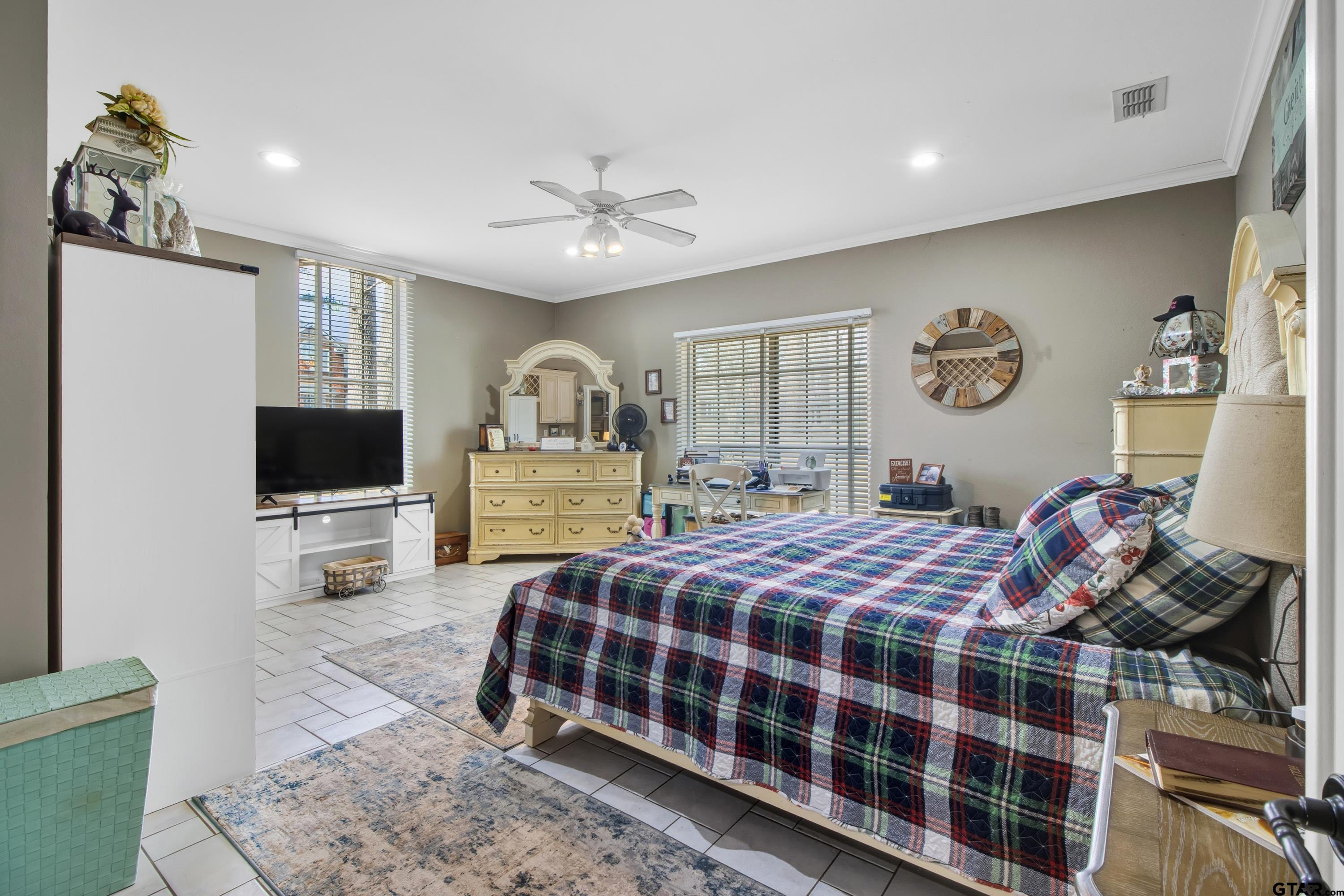 3800 Holly Ridge Drive Longview, TX 75605 - Photo 8 of 38 a bedroom with a bed a window and a flat screen television