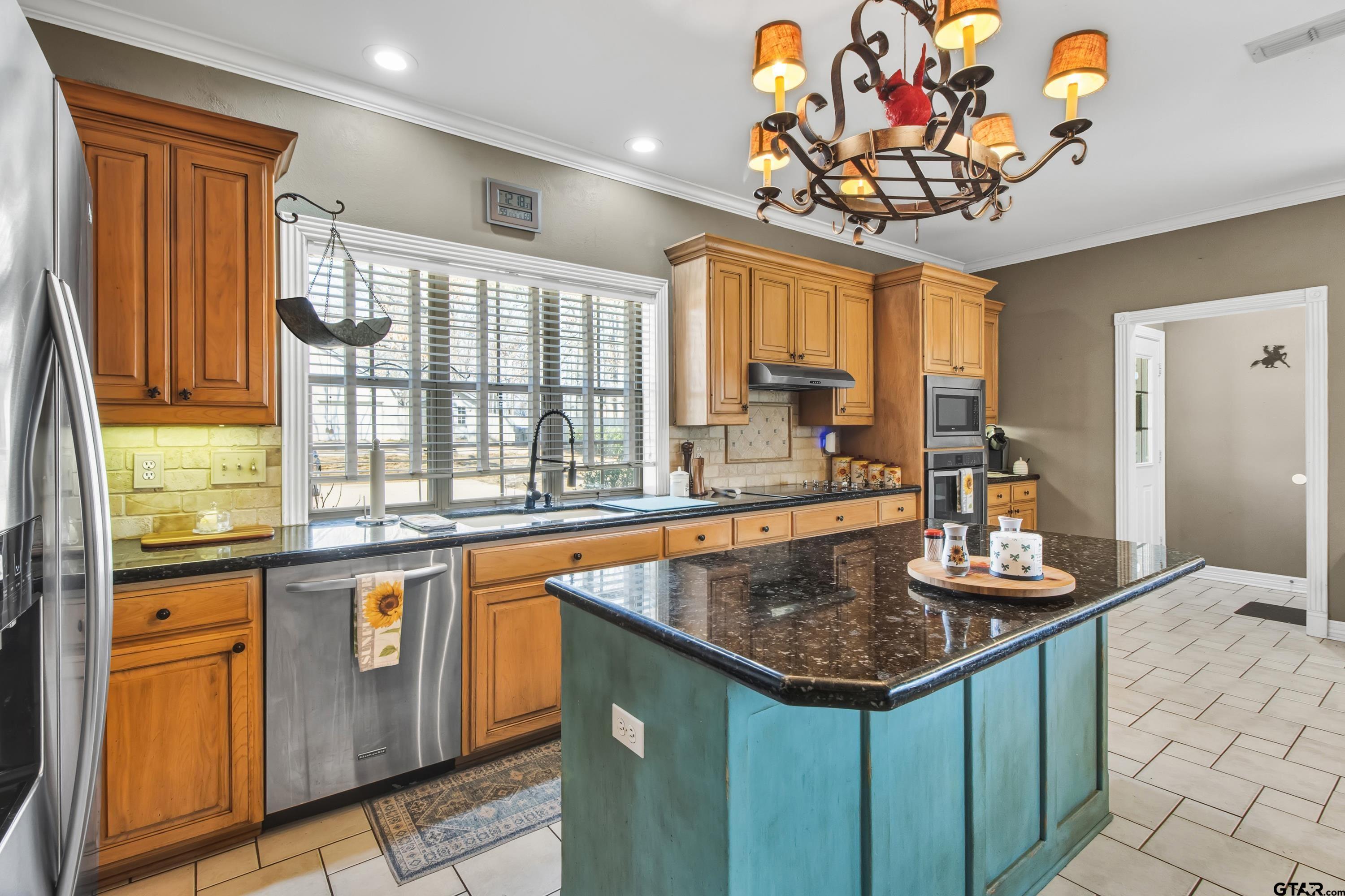 3800 Holly Ridge Drive Longview, TX 75605 - Photo 10 of 38 a kitchen with stainless steel appliances granite countertop a stove and a sink