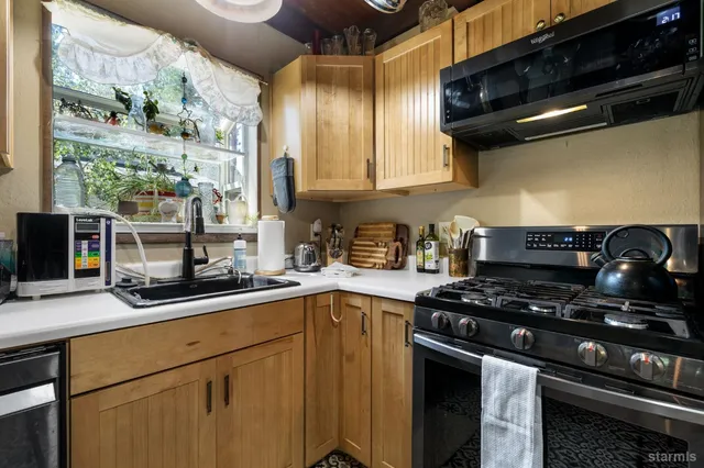 a kitchen with stainless steel appliances a sink and a stove